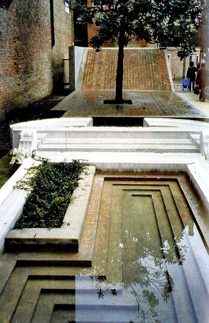 a tree that is sitting in the middle of some concrete steps with plants growing out of them