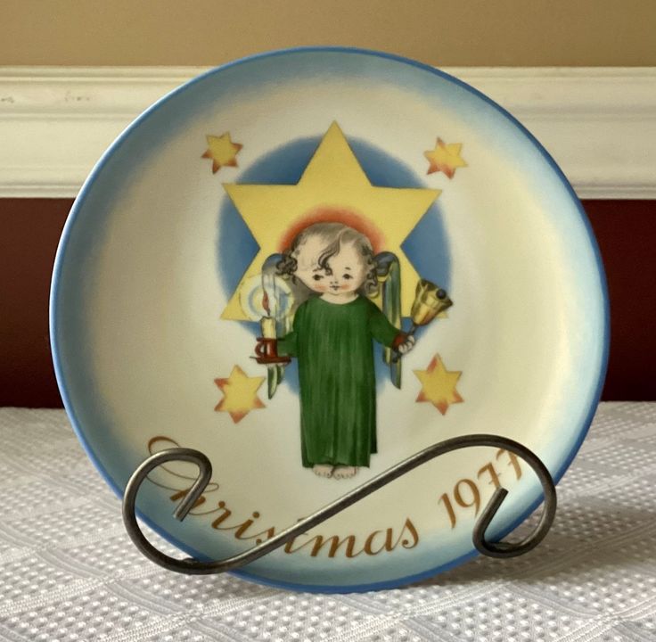 a christmas plate with an angel holding a star on the front and writing merry christmas to you