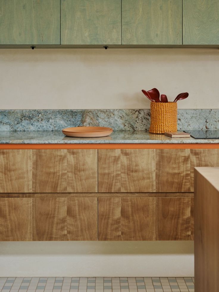 a kitchen with wooden cabinets and counter tops