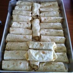 a pan filled with tortillas sitting on top of a wooden table