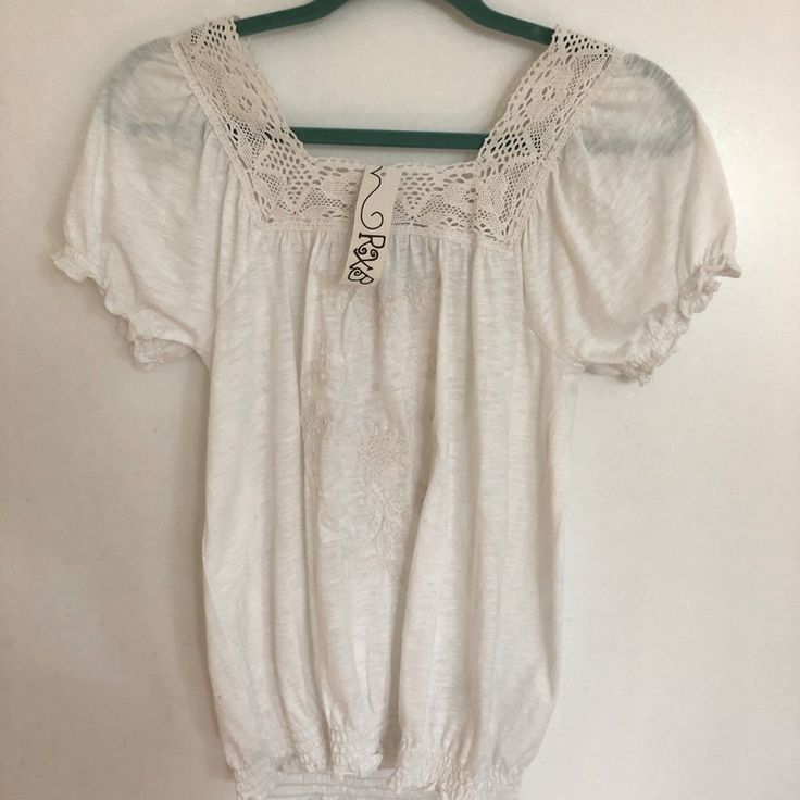 100% Cotton Top With Lace Trim. Elasticized Sleeves And Bottom. Embroidered Pattern In Front. Very Light Cotton Perfect For Staying Cool In The Fire Swamp Summer ! Beige Casual Peasant Top For Daywear, Casual Beige Peasant Top For Daywear, Casual White Blouse With Crochet Trim, Casual Cream Peasant Top, Casual Embroidered Top With Lace Trim For Summer, Casual Beach Peasant Top With Floral Embroidery, Bohemian Short Sleeve Top With Crochet Trim, Casual Summer Peasant Top With Crochet Trim, Casual Short Sleeve Crochet Top With Lace Trim