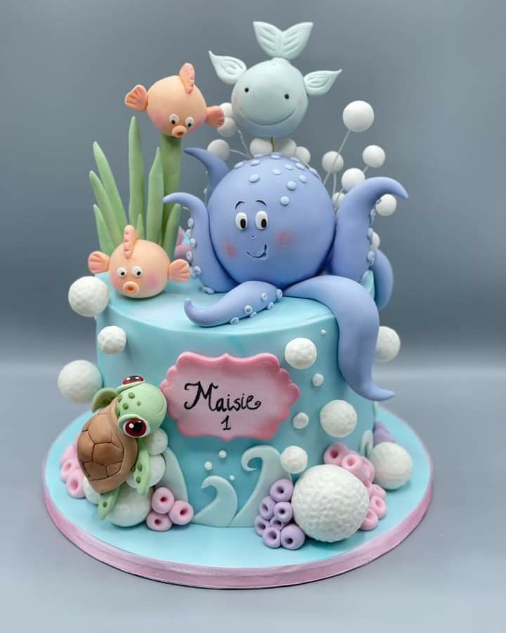 a blue cake with an octopus and other sea creatures on it