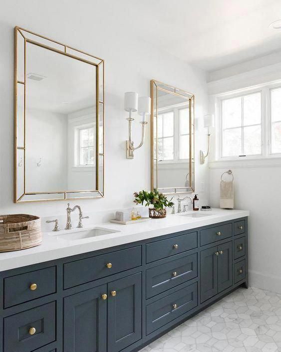 a bathroom with two sinks and large mirrors on the wall next to eachother