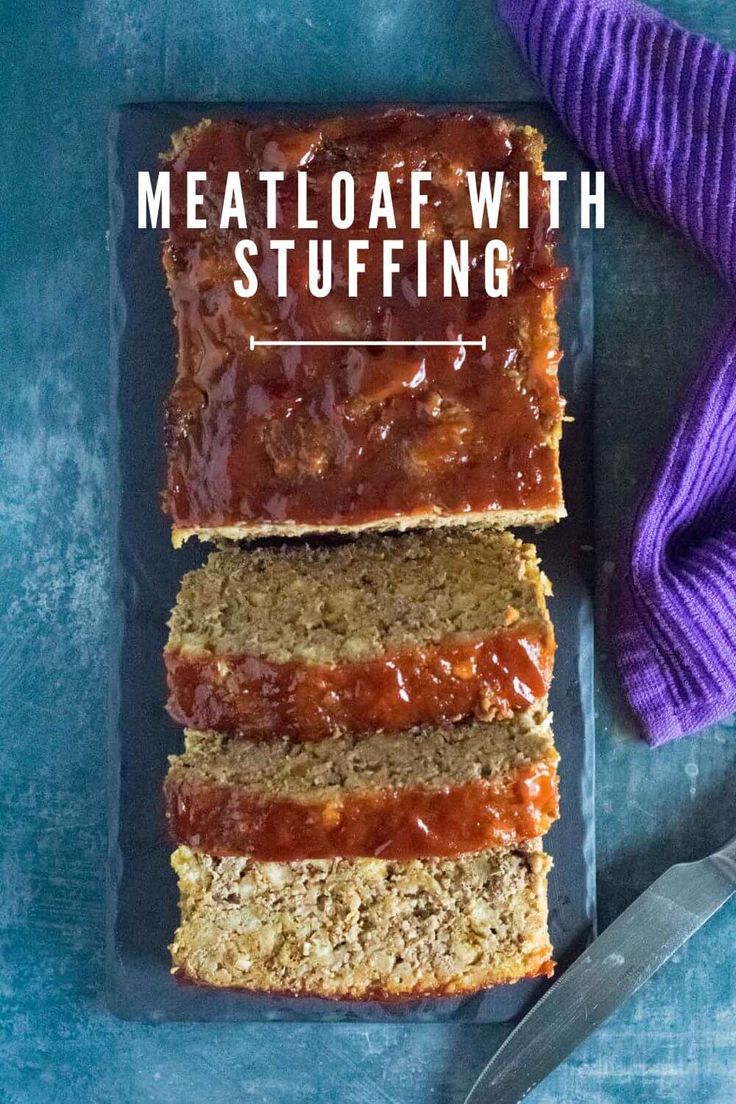 meatloaf with stuffing on a blue plate next to a purple towel and knife