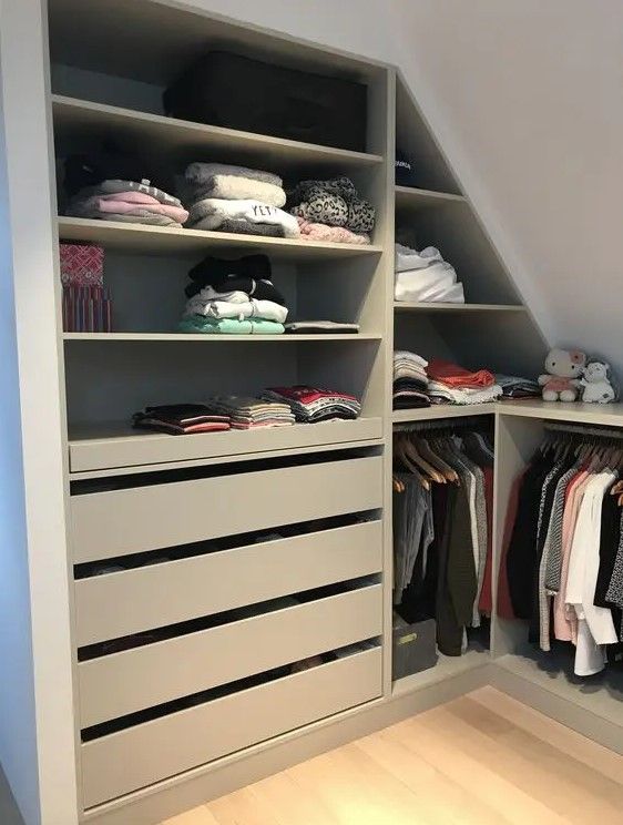 an organized closet with clothes on shelves