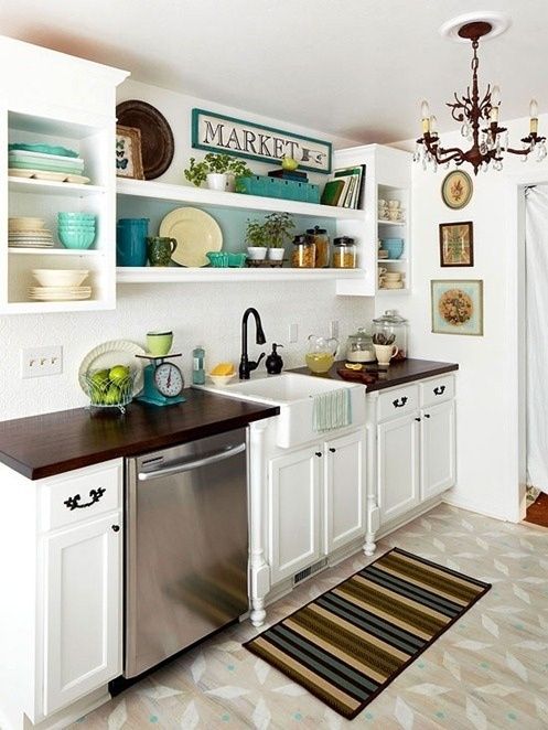 the kitchen is clean and ready to be used for cooking or baking, with dishes on shelves above the sink