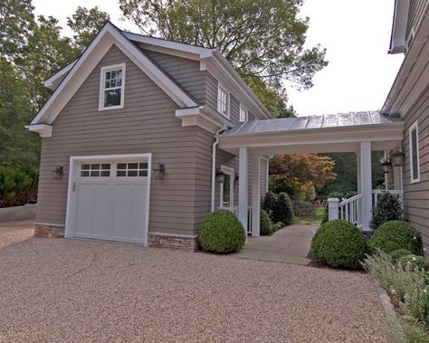 a gray house with white trim and two garages