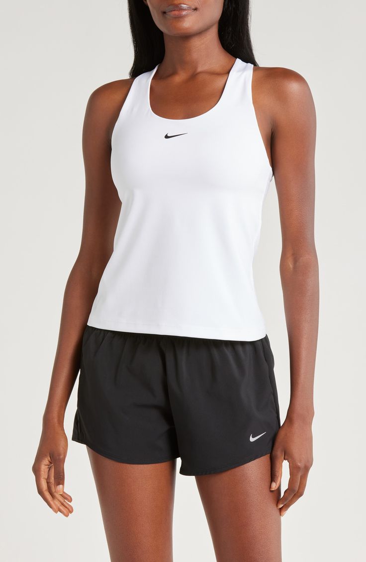 A built-in shelf-bra keeps you supported in this racerback tank top cut with signature Dri-FIT technology for cool, dry comfort as you work up a sweat. 20 1/2" length (size medium) Scoop neck Racerback Built-in shelf-bra Dri-FIT moisture-wicking technology 82% polyester, 18% spandex Machine wash, line dry Imported Nike Tops For Light Sports, White Racerback Top With Mesh Back, White Mesh Back Racerback Top, White Racerback Running Top, White Racerback Tank Top With Mesh Back, Nike Racerback Tops For Sports Events, Nike Racerback Sports Bra For Running, Nike Racerback Activewear For Light Sports, Nike Sporty Racerback Tops