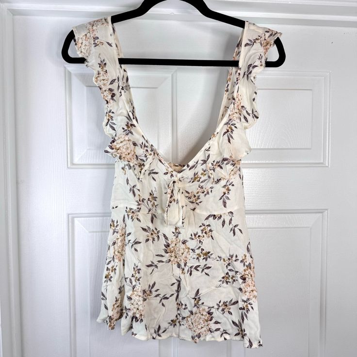 New With Tag Ivory, Floral Print Tank Top With Ruffle Shoulder Straps, V-Neck With Bow Size S Pit To Pit 15.5” Length 25” The Item Pictured Is The Exact One You’ll Receive. Open To Offers! Off White V-neck Top For Daywear, Off White V-neck Top For Day Out, Off White V-neck Blouse For Day Out, White V-neck Summer Blouse, Cream V-neck Top For Beach, White V-neck Top For Brunch, Cream V-neck Top For Daywear, White V-neck Tops For Daywear, Off White V-neck Top For Vacation