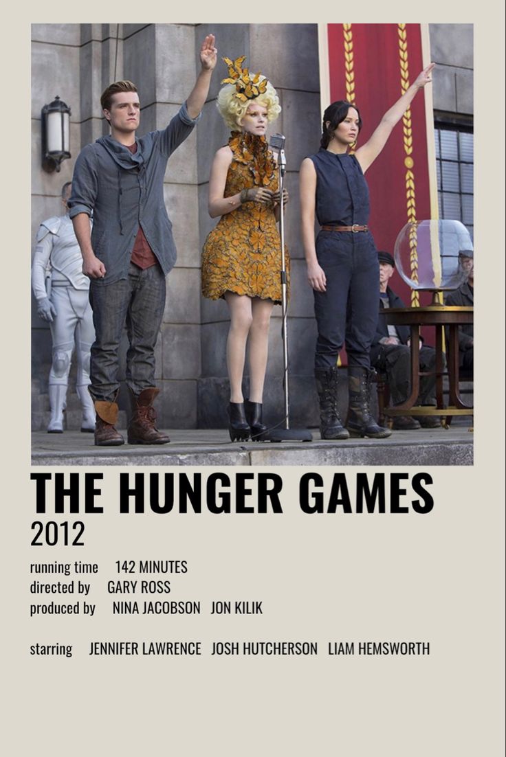 a movie poster for the hunger games with two actors standing on stage and pointing at something