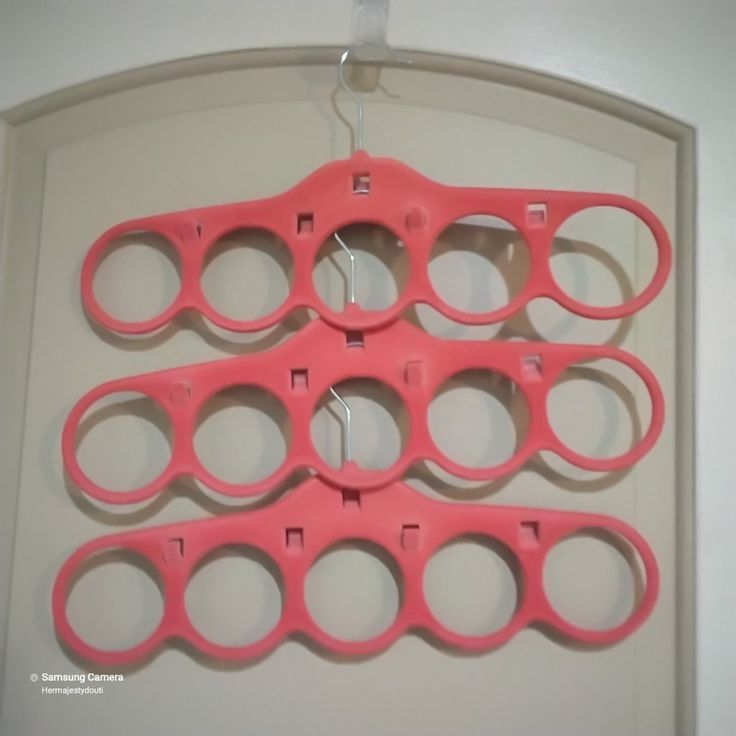 several pairs of scissors hanging on a wall