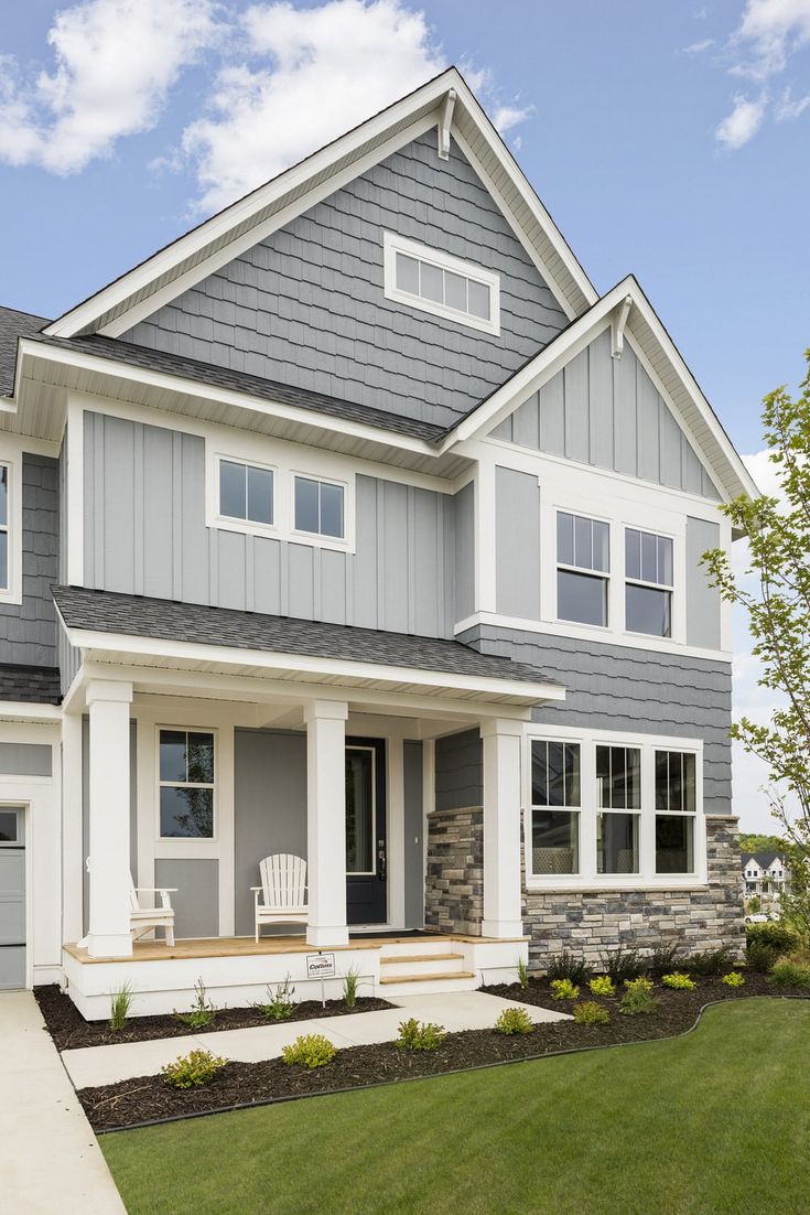 a large gray and white house with lots of windows