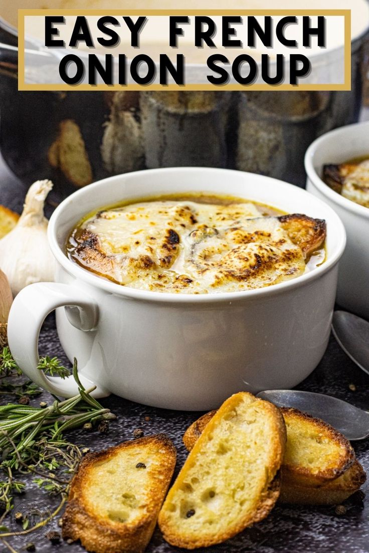 french onion soup in a white bowl with garlic bread on the side