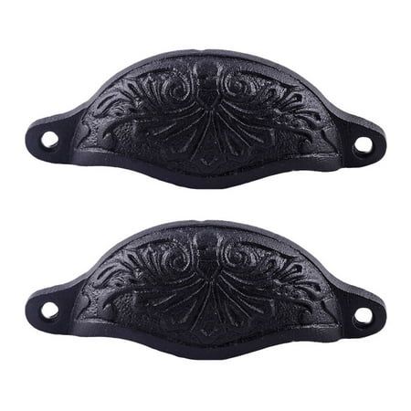 two black handles with ornate designs on them, one has a hole in the middle