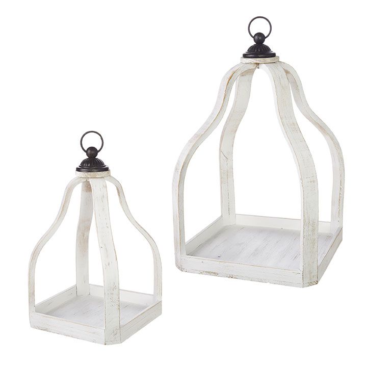 two white wooden lanterns with metal handles