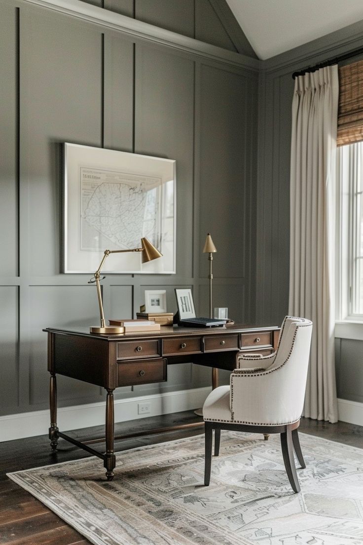 a desk with a chair, lamp and pictures on the wall