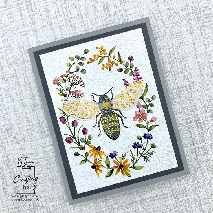 a card with a bee and flowers on it