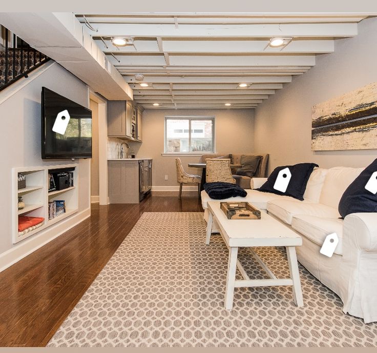 a living room filled with furniture and a flat screen tv on top of a wooden floor