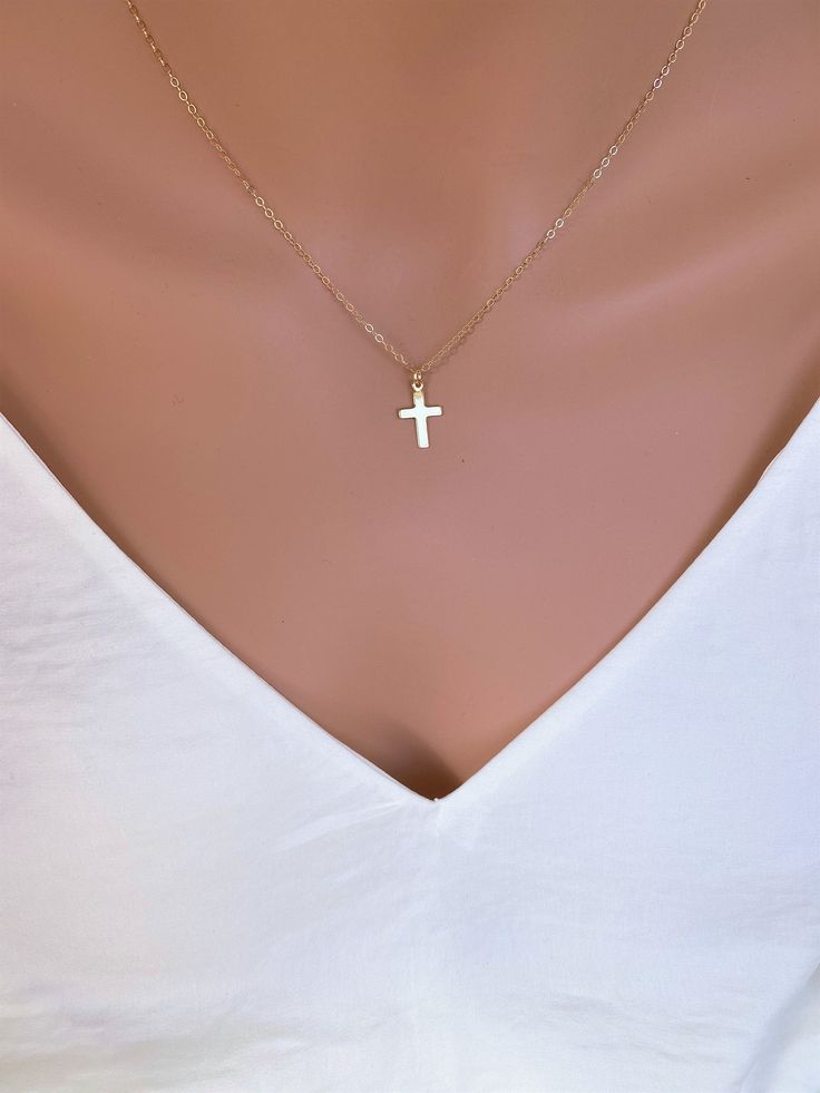 Dainty 14k Gold fill Cross Necklace Woman. Super cute small cross necklace is great gift for her Christmas, This necklace is made of.... -14k gold fill 15mm cross pendent, and -14k gold fill cable chain with spring clasp, -Come up with beautiful ribbon gift box and -One set of Care instruction package. MORE CROSS JEWELRY https://www.etsy.com/shop/rainbowearring?search_query=CROSS MORE LAYERED NECKLACES https://www.etsy.com/shop/rainbowearring1?section_id=17891444&ref=shopsection_leftnav_5 CO Minimalist Cross Charm Necklace With Delicate Chain, Minimalist Cross Pendant Charm Necklace, Simple Cross Jewelry With Delicate Chain, Simple Yellow Gold Cross Necklace, Minimalist Cross Necklace With Delicate Chain Crucifix, Minimalist Crucifix Cross Necklace With Delicate Chain, Minimalist Crucifix Jewelry With Delicate Chain, Simple Cross Clavicle Chain Jewelry, Simple Clavicle Chain Cross Jewelry