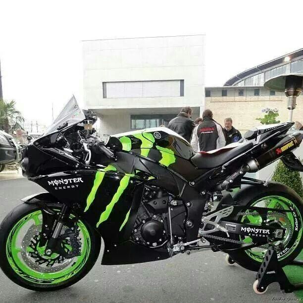 a black and green motorcycle parked on the street