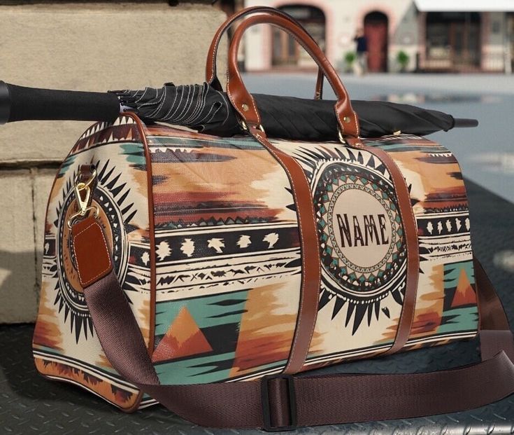 This personalized boho western travel bag is all about style. Our custom monogrammed southwestern duffel bag is made with high-grade waterproof fabric, it's a highly durable means of transferring your essentials wherever you go. Our weekender waterproof leather tote bag has multiple compartments, a resilient carrying handle, and an adjustable shoulder strap, it's the perfect companion for all your adventures. This southwestern tribal Indian style design will have everyone asking where did you ge Bohemian Tote Duffle Bag For Weekend Trips, Bohemian Weekender Bag With Luggage Sleeve For Travel, Bohemian Weekender Bag For Weekend Trips, Bohemian Brown Weekender Bag For Weekend Trips, Bohemian Style Rectangular Duffle Bag For Weekend Trips, Bohemian Travel Bag With Luggage Sleeve For Weekend Trips, Bohemian Weekender Bag With Luggage Sleeve For Weekend Trips, Bohemian Large Capacity Duffle Bag For Weekend Trips, Bohemian Rectangular Duffle Bag For Weekend Trips