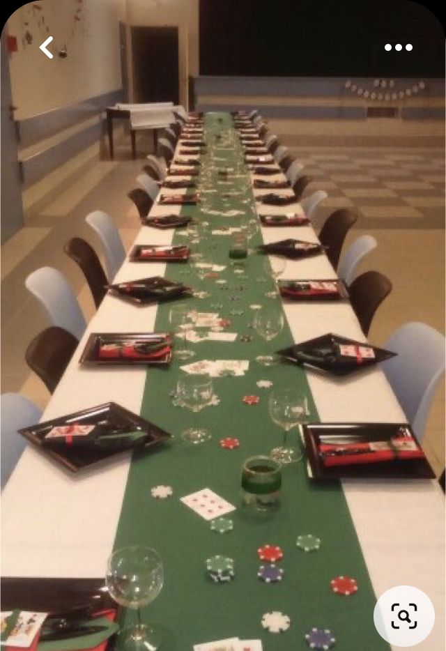 a long table is set up with cards and place settings for the guests to sit at