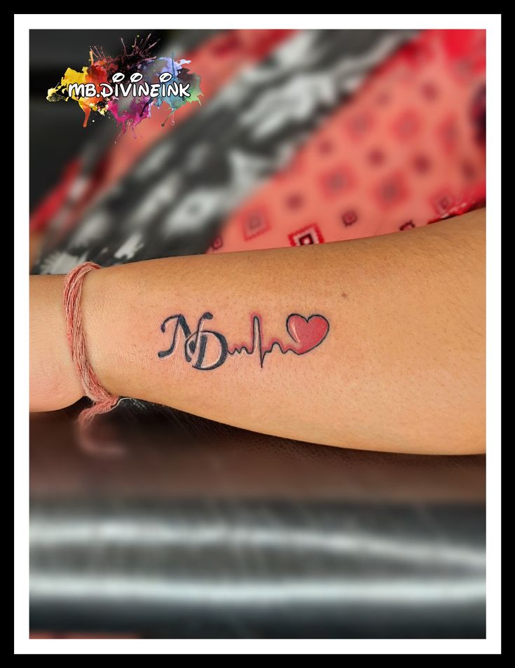 a woman's arm with a heartbeat tattoo on it