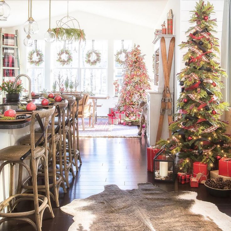 a living room filled with furniture and christmas trees