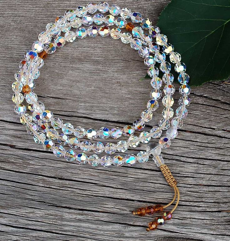 Swarovski Crystal Mala. 108 8mm cool, clear faceted Swarovski Crystal beads w/Citrine-colored markers, finished w/aQuartz Crystal guru bead & adjustable Snakeknot. Clear Crystal Spiritual Necklaces, Spiritual Clear Crystal Necklace, Clear Beaded Crystal Bracelet With Round Beads, Faceted Round Crystal Bead Necklaces, Adjustable Sparkling Crystal Bracelet, White Spiritual Crystal Necklaces With Faceted Beads, White Spiritual Crystal Necklace With Faceted Beads, Adjustable Crystal Bracelet With Faceted Beads, Adjustable Faceted Crystal Bracelet With Round Beads