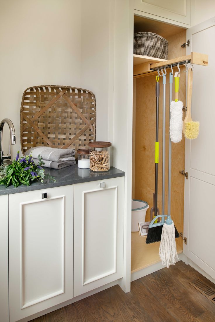 a bathroom with white cabinets and an open door