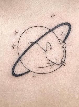 a cat is sitting on top of the saturn tattoo