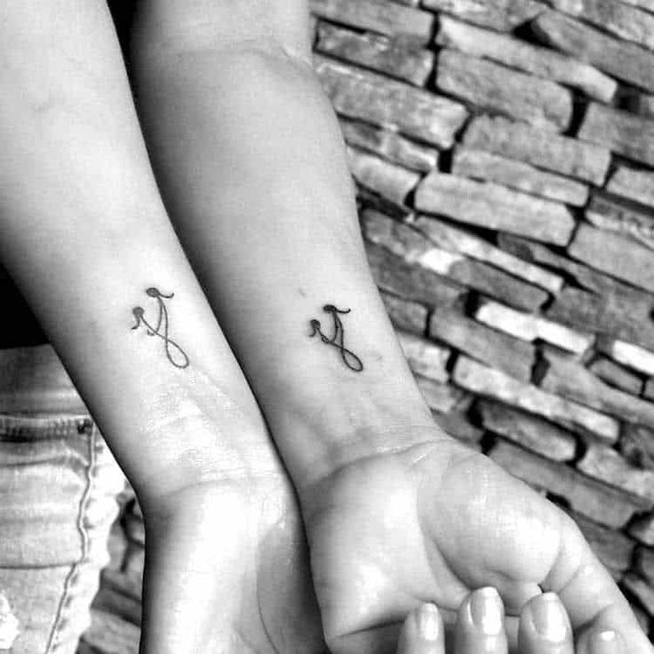 two people with matching tattoos on their arms