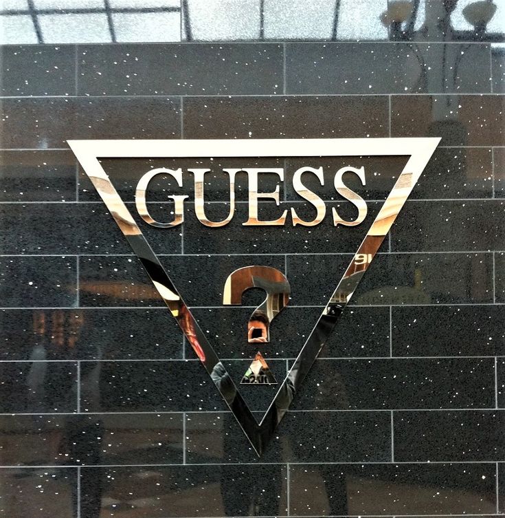 there is a sign on the wall that says guess