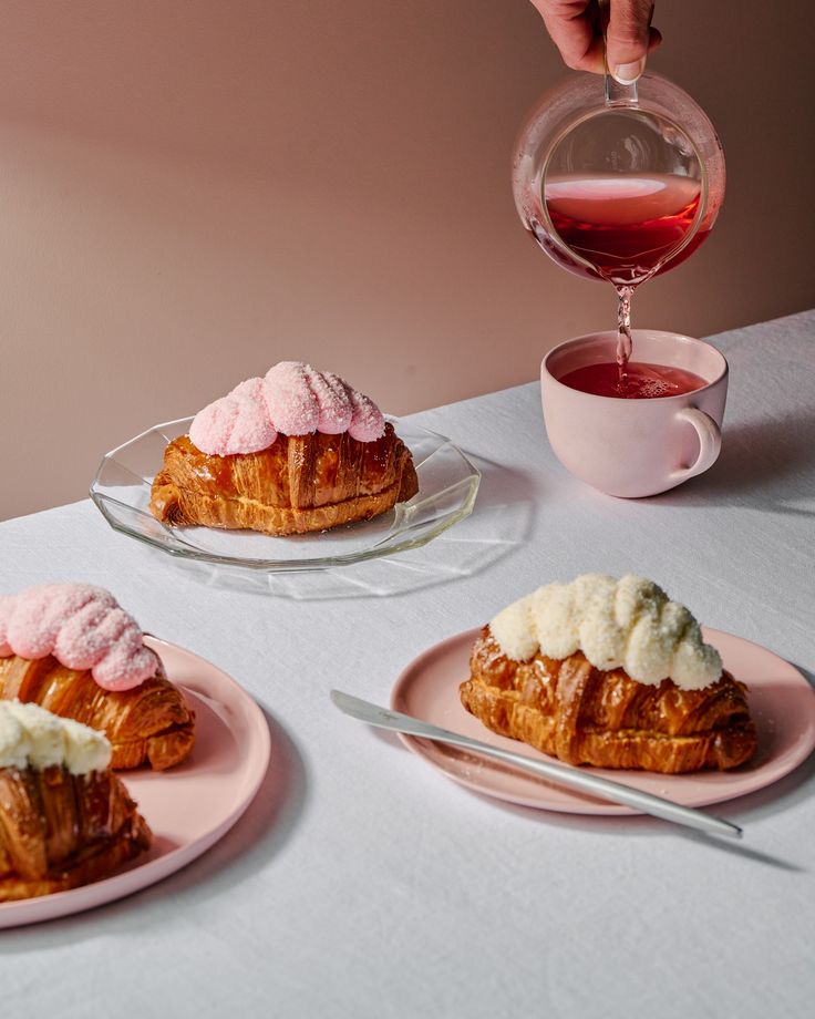 three plates with pastries on them sitting on a table