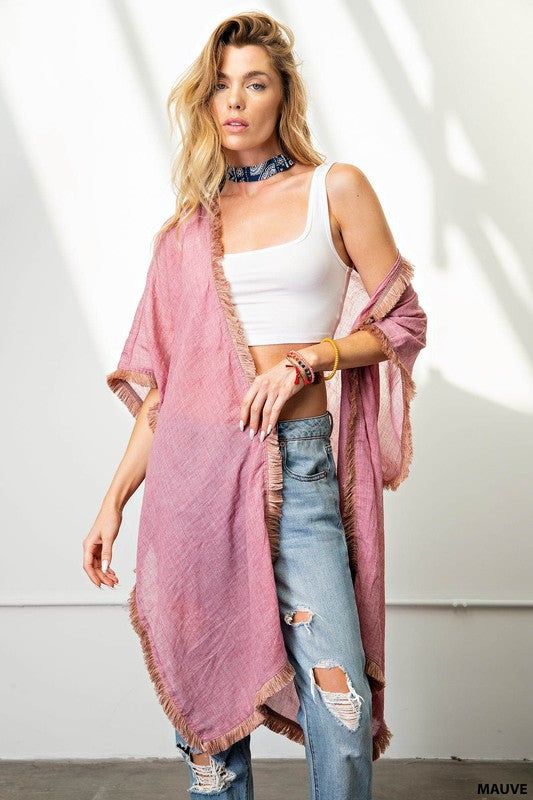 Experience the ease and elegance of our fringe trim kimono. Crafted from a light-weight, soft fabric, this versatile cover-up is perfect for any event. Perfectly suited for dressy occasions and both day and night events, the kimono offers a flattering, loose fit that can be dressed up or down, worn over shorts, jeans, or a beautiful dress. Enjoy the fun and beauty of the fringe trim for an effortless look. Chic Spring Unlined Cover-up, Chic Unlined Spring Cover-up, Chic Spring Layering Cover-up, Spring Loungewear Tunic Kimono, Spring Cotton Tunic Kimono, Spring Tunic Kimono For Loungewear, Cotton Tunic Kimono For Spring, Fringe Kimono For Beach In Fall, Spring Beach Cover-up Duster