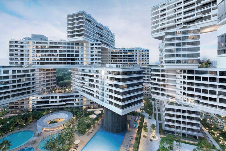 an aerial view of several buildings with pools in the foreground