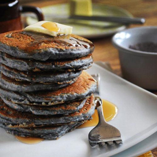 a stack of pancakes sitting on top of a white plate