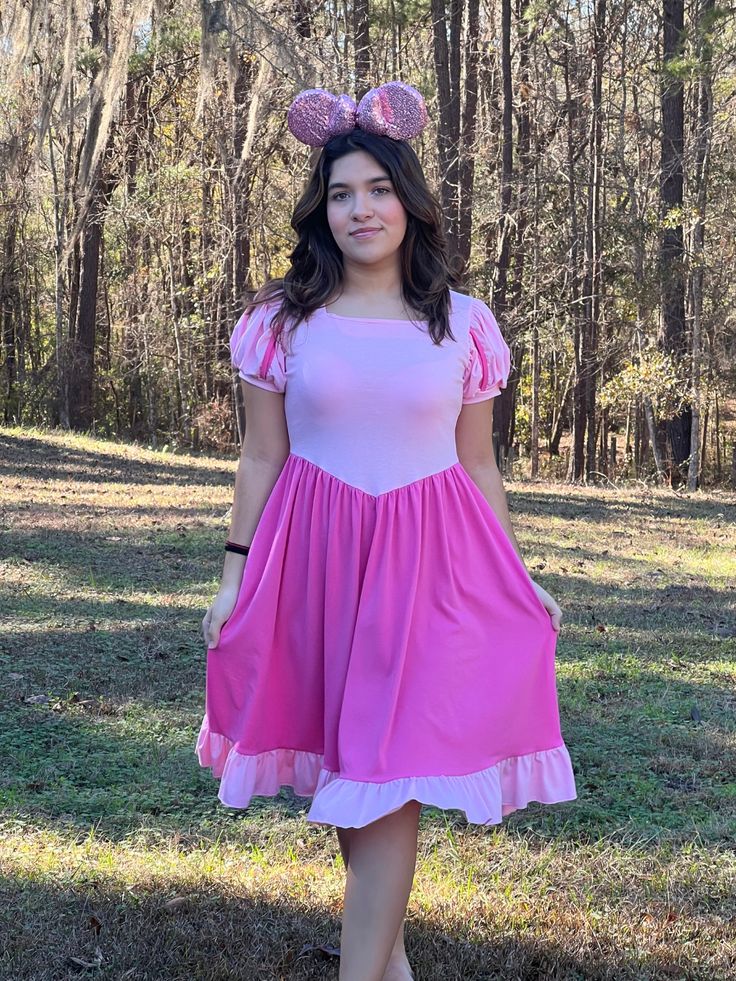 Our Sleeping Beauty dress features two shades of pink in a romantic and delicate pattern. It makes a perfect Disneybound piece, just add your favorite princess Aurora accessories and you will look amazing at the parks! Ruffled bottom. Ballgown puffy sleeves. It has pockets. Soft 95% cotton and 5% spandex. Pink Short Sleeve Dress For Costume Party, Fairytale Costume Party Dress With Fitted Bodice, Pink Fitted Empire Waist Dress, Fairytale Style Fitted Dress For Costume Party, Fairytale Fitted Dress For Costume Party, Fitted Fairytale Dress With Ruffles, Pink Sweetheart Neckline Dress For Costume Party, Pink Dress With Sweetheart Neckline For Costume Party, Fitted Princesscore Dresses