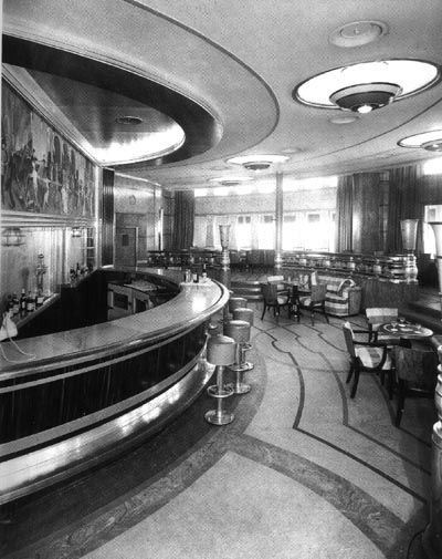 an old photo of a restaurant with tables and chairs in the middle of the room