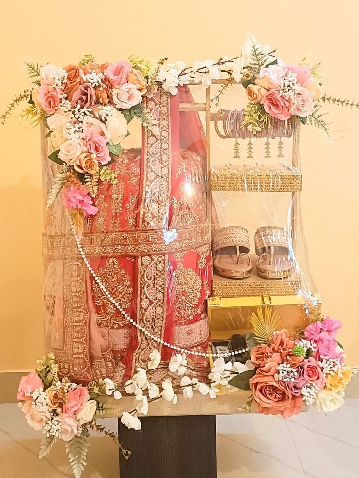 an arrangement of flowers and jewelry on display