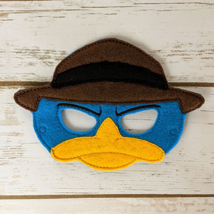 a blue bird wearing a brown hat and glasses with a felt mask on it's face