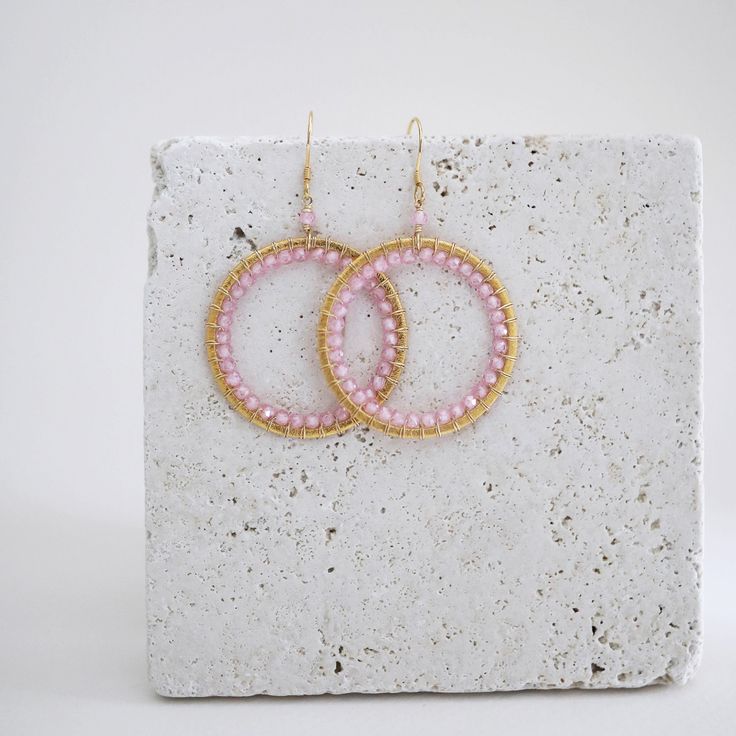 Rose quartz gemstone hoop earrings - 2.5" long- French hooks- 14k gold plated .925 fine Italian sterling silver - Made in the USA in our NYC studio- Packaged in a gift box- Free shipping on US orders Handmade to last. Our unique gold plating technique makes our jewelry tarnish resistant. The nature of natural gemstones makes each style one-of-a-kind. Modern Pink Small Hoop Earrings, Modern Pink Small Hoop Jewelry, Handmade Crystal Earrings For Everyday, Bohemian Pink Circular Jewelry, Bohemian Pink Circle Jewelry, Handmade Small Hoop Crystal Earrings, Modern Wire Wrapped Round Hoop Earrings, Modern Wire-wrapped Round Hoop Earrings, Pink Wire Wrapped Round Earrings