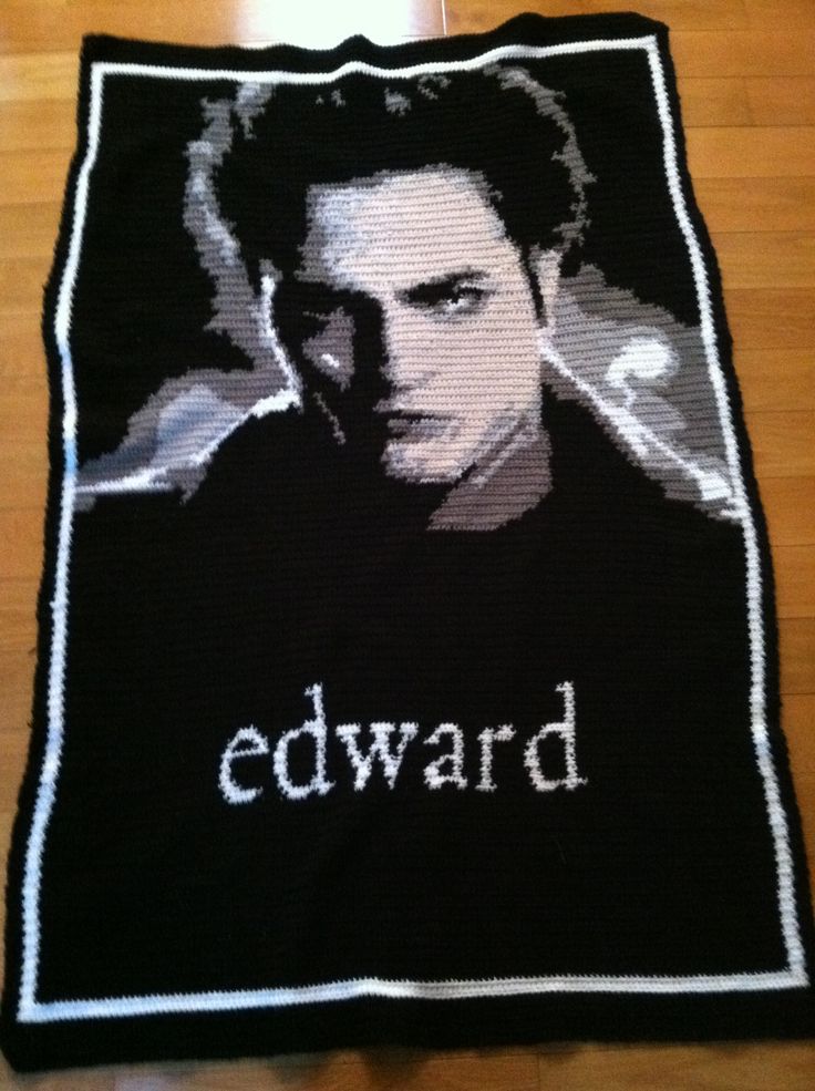 a knitted blanket with the image of edward scissor on it, sitting on top of a wooden floor