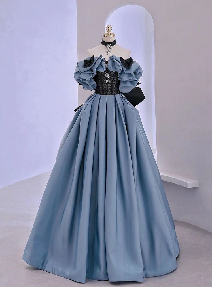 Forging an unforgettable presence, this prom dress is a testament to the fusion of classic elegance and modern couture. The dress features a majestic steel blue hue, accented with a dramatic black lace bodice that intricately weaves sophistication with allure. Voluminous puff sleeves and a sweeping full skirt create a silhouette reminiscent of regal ballgowns, while the stark contrast of colors injects a contemporary edge. This gown, complete with a cinched waist and delicate lace detailing, stands as a unique piece for those seeking to make a bold statement at prom.Silhouette:a-lineHemline:floor lengthNeckline:off the shoulderFabric:satinShown Color:blueSleeve Style:sleevelessBack Style:lace upEmbellishment:lace bowBuilt-in Bra: yes Prom Dress Off Shoulder, डिजाइनर कपड़े, Lace Long Prom Dress, Off Shoulder Evening Dress, 파티 드레스, Old Fashion Dresses, Dress Off Shoulder, Blue Evening Dresses, فستان سهرة