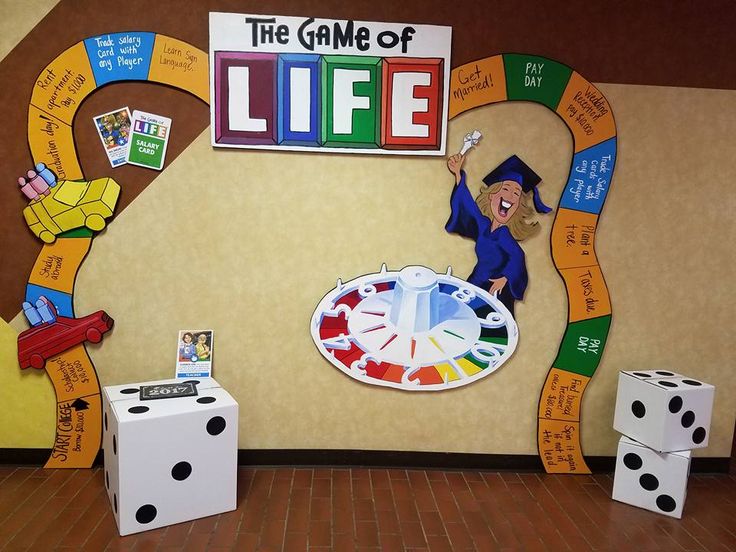 the game of life is displayed in front of a wall with dices on it