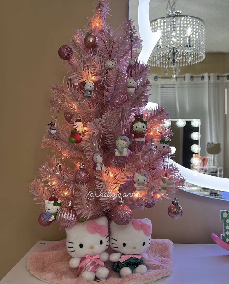 a pink christmas tree with hello kitty ornaments