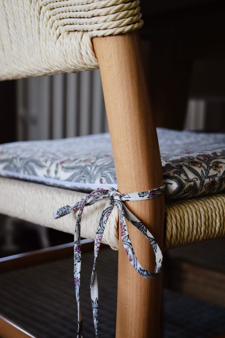 a close up of a chair with rope tied to it