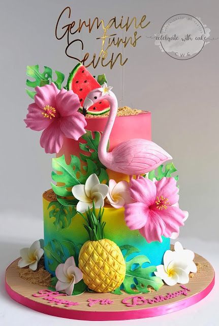 there is a cake decorated with flowers and a flamingo