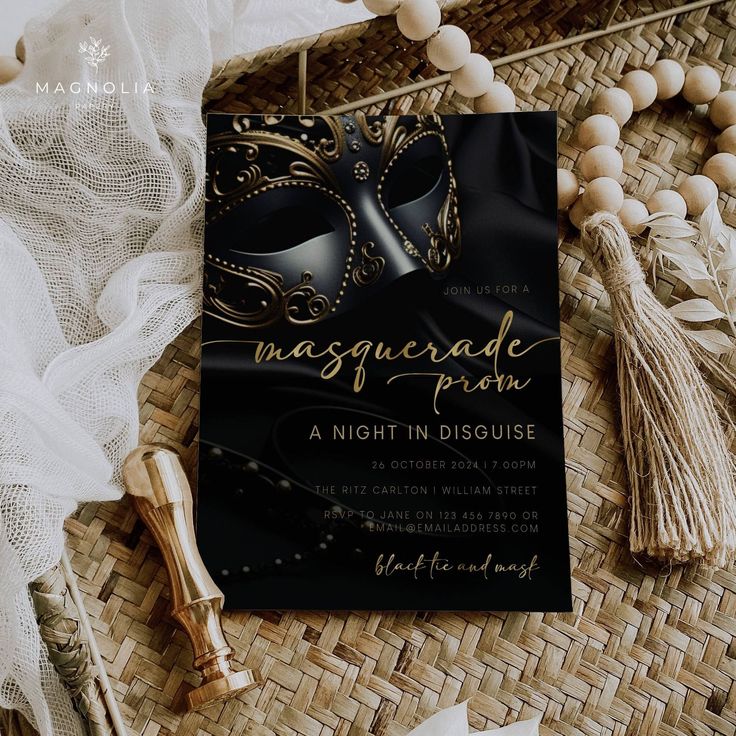 a black and gold masquerade party card on top of a wicker mat