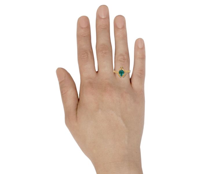 Captivating in its one-of-a-kind characteristics and earthy design, this Lunar Rain ring exudes a playful sophistication. The teardrop shaped bright green emerald is surrounded by the matte, 18K yellow gold frog which has been set with tiny shimmering blue sapphire eyes and wears a tiny gold crown. The composition sits at the center of the 18K yellow gold band. ring face : just over 1/2" x 3/8"emerald : 8mm x 6mmblue sapphires : 1mm diameter each18K yellow gold band width : 2.5mmsize available : Green Teardrop Emerald Rings, Teardrop Green Emerald Rings, Green Emerald Teardrop Rings, Teardrop Emerald Green Rings, Green Teardrop Emerald Ring For May Birthstone, Green Teardrop 14k Gold Ring, Green Teardrop Fine Jewelry Ring, Frog Prince Ring, Jennie Kwon Ring